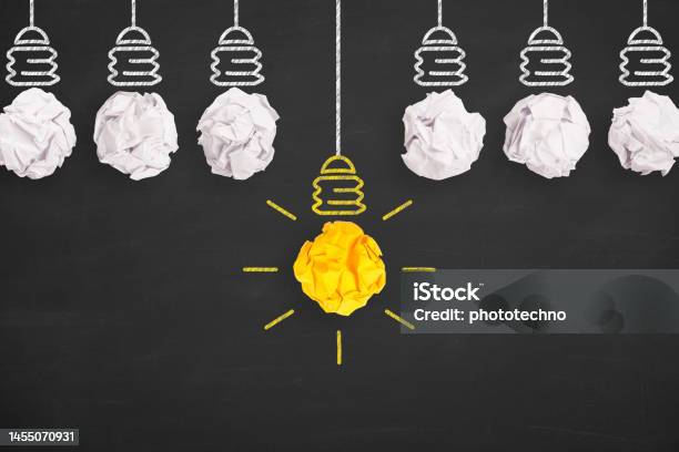 Idea Solution Concepts Light Bulb Crumpled Paper On Blackboard Background Stock Photo - Download Image Now