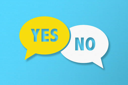 Yes or No and Speech Bubbles with Copy Space On Blue Cardboard Background