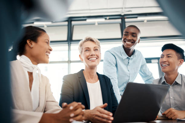 Teamwork, collaboration and business people on laptop with leader brainstorming ideas in office. Innovation, workers or company employees on computer planning strategy, working or in sales meeting. Teamwork, collaboration and business people on laptop with leader brainstorming ideas in office. Innovation, workers or company employees on computer planning strategy, working or in sales meeting. multi ethnic group group of people people smiling stock pictures, royalty-free photos & images