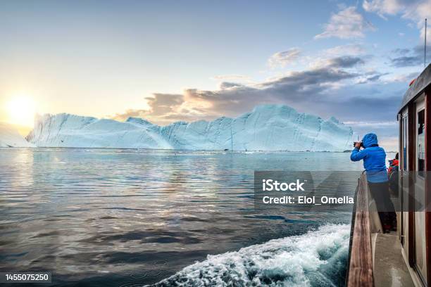 Travel In Arctic Landscape Nature With Icebergs Tourist Man Explorer From A Boat At Sunset Greenland Stock Photo - Download Image Now
