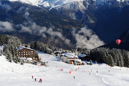 Winter scenery in French alps with skiing people