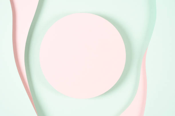 istock Blank pink round geometric shape podium platform on paper cut abstract geometric shape pastel pink and green background. Top view mock up for product display 1455077273