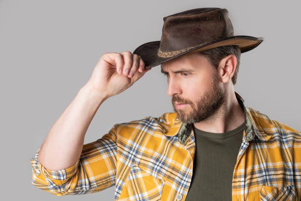istock west man with cowboy hat isolated on grey background. west man in cowboy hat in studio. 1455077504