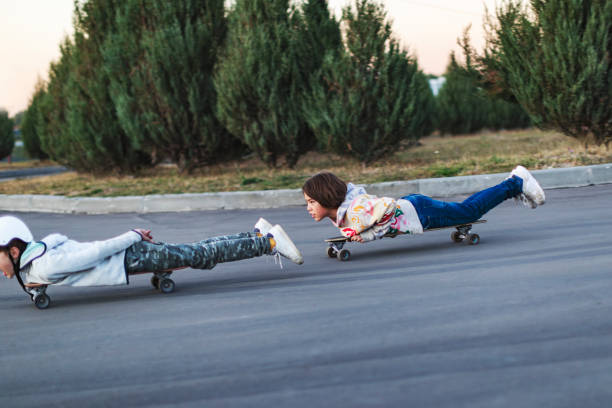 istock School age brothers skateboarding in park 1455078800