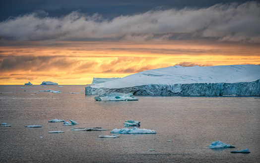 istock Iceberg on beautiful sea in the sunset 1455079162