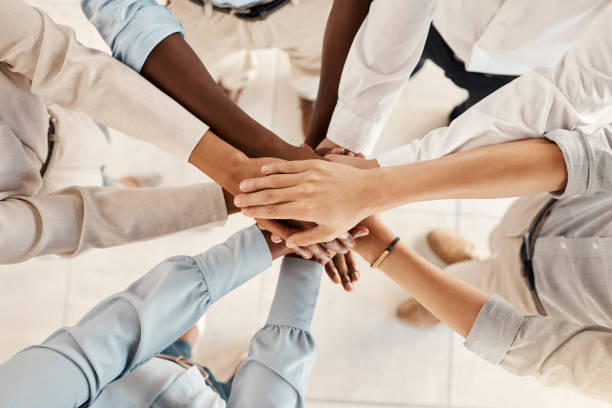 istock Group hands stack, support business team and motivation solidarity together in office with diversity. Success hand teamwork, multicultural colleagues collaboration and corporate people from above 1455080213