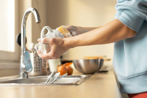 Woman washing dirty dishes