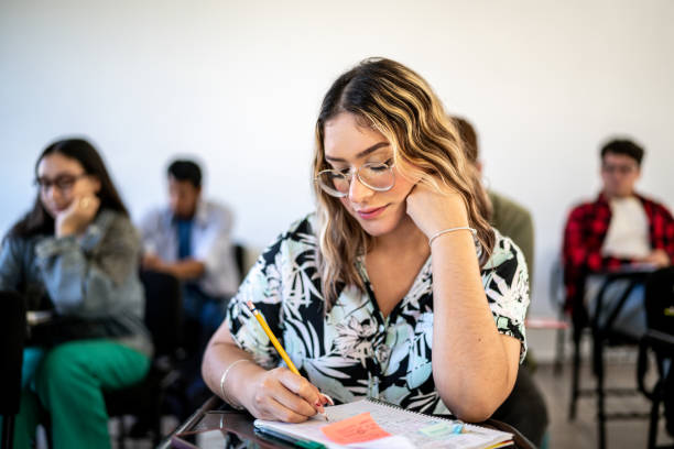 istock Young woman studying in the classroom at university 1455082407