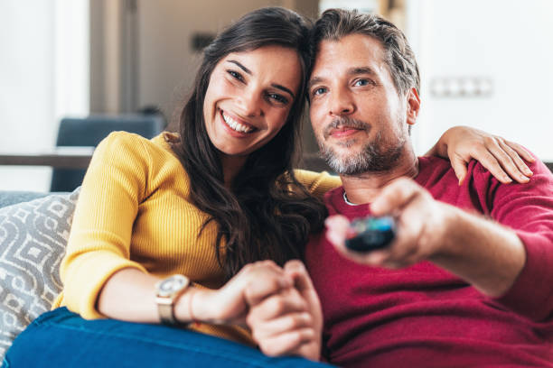 istock Happy couple watching tv 1455086095