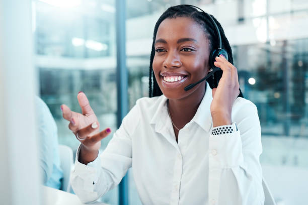 istock Communication, call center and black woman consulting at computer with professional customer online. Telemarketing consultant listening to internet client with smile in corporate workplace. 1455086418