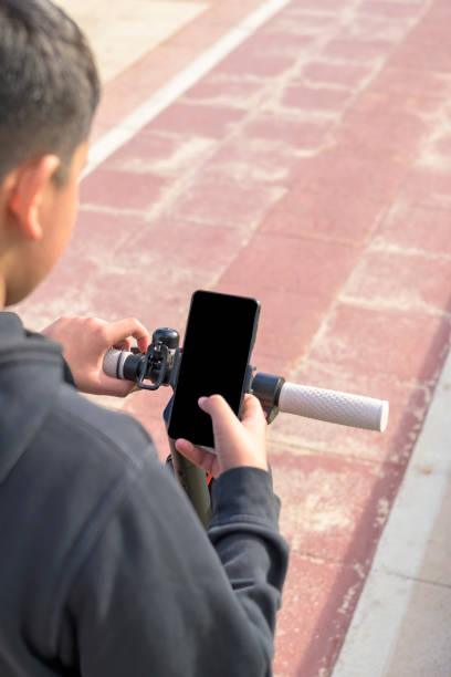 istock E-Mobility, using smartphone application activation of electric scooter, green mobility concept 1455086592