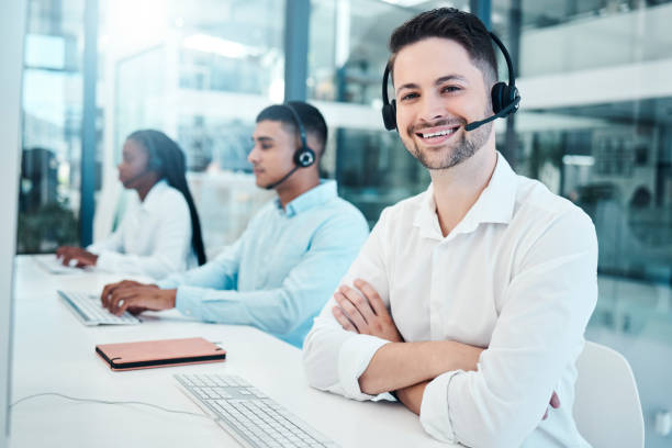istock Customer service, call center and support with a man consulting using a headset in a sales office. Ecommerce, contact us and telemarketing with a male consultation working as a professional crm agent 1455086618