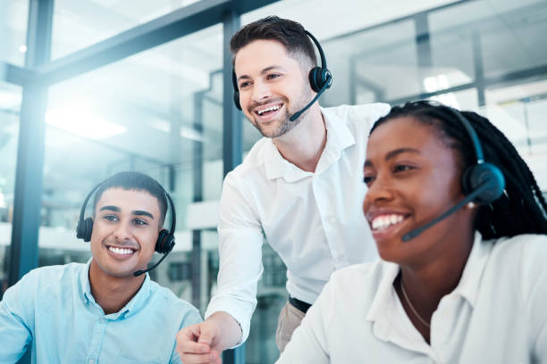 istock Customer support, call center and team working together in office, manager helping workers. Diversity, teamwork and boss with consulting agents in customer service, telemarketing and crm workplace 1455087746
