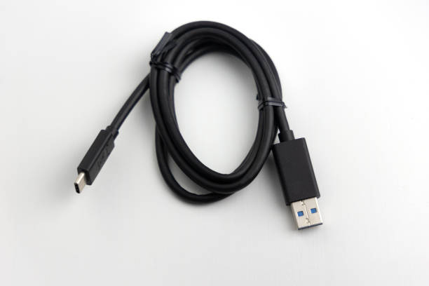 istock New coiled black USB accessory cable with large and small connectors against a white background 1455090745