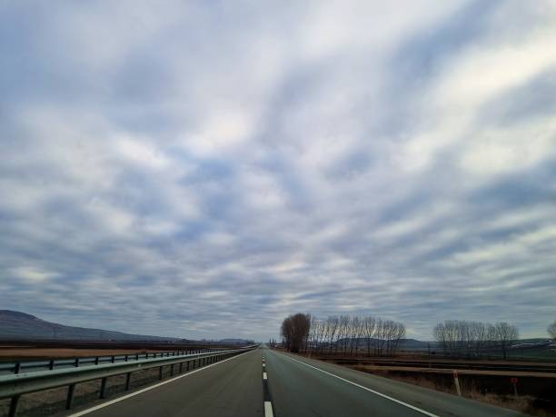istock View of an empty road with a sky full of clouds 1455091063