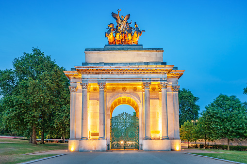 The landmark Wellington Arch in London England UK illuminated at twilight blue hour.