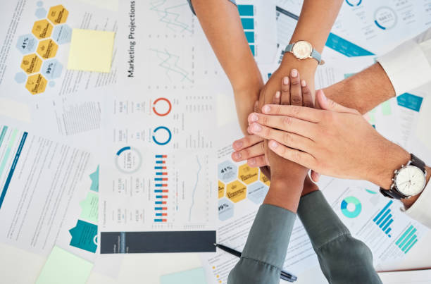 istock Team hands, marketing collaboration and teamwork support for financial reports in office. Diversity, corporate employee trust and business partnership motivation or goal achievement success at desk 1455095649
