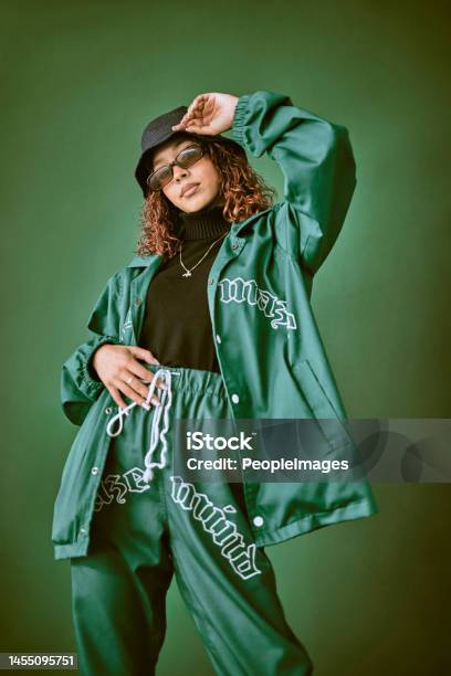 Fashion Clothes Style And Black Woman With Green Rap Gen Z Or Hip Hop Aesthetic Outfit For Cool Edgy Or Fashionable Look Designer Brand Apparel Attitude Or Teen Fashion Model On Green Background Stock Photo - Download Image Now