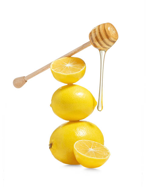 istock Lemons with honey on a white background 1455095820