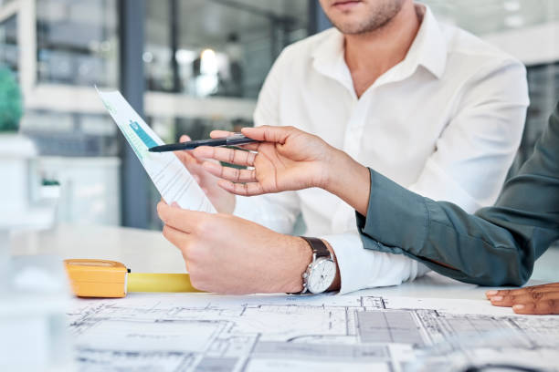 istock Business people, architect hands and meeting in planning for floor plan, construction or design at the office. Hand of creative employee designers in team strategy for architecture or project plan 1455095963