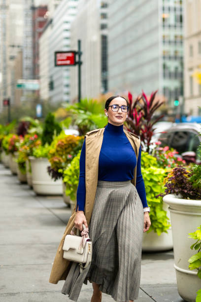 istock A nicely dressed businesswoman seen walking in Manhattan after work 1455097168