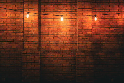 Light bulbs on brick wall background