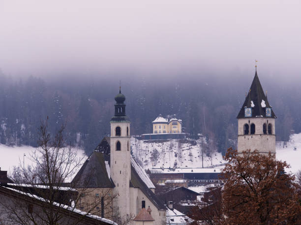 Alpine cityscape during misty afternoon, Kitzbuhel, Austria