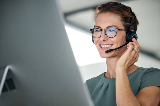 istock Customer service, woman and happy call center agent giving advice online using a headset. Operator, telemarketing and support with hotline consultant working for contact us help or arm consulting 1455098636