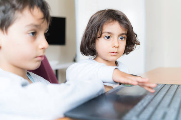 Kids with mother doing homework outdoors.