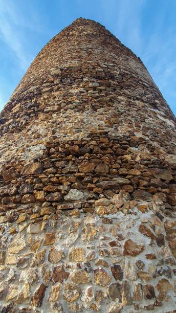 istock Vertical shot of an ancient round tower with a stone wall 1455099595