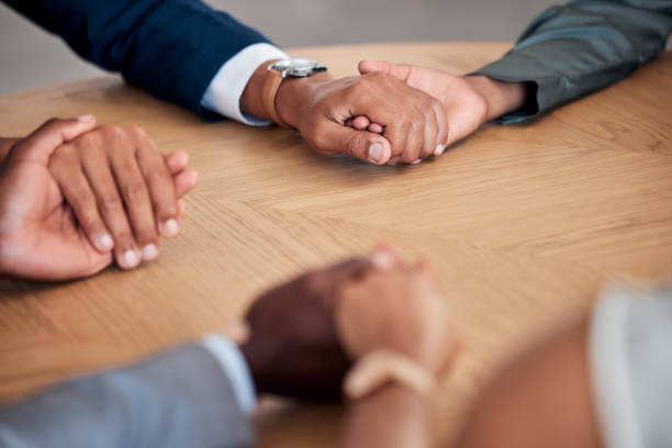 istock Holding hands, therapy circle and community support group for stress, anxiety and depression in the corporate workplace to prevent burnout. Business people, mental solidarity and health with empathy 1455108305