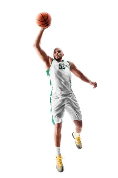 Photo of Basketball player in a jump. Sport energy. Sport emotion. Isolated