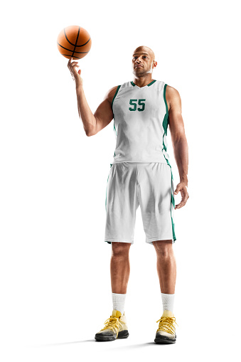 Basketball player spins the ball on his finger. Professional basketball player standing in white background