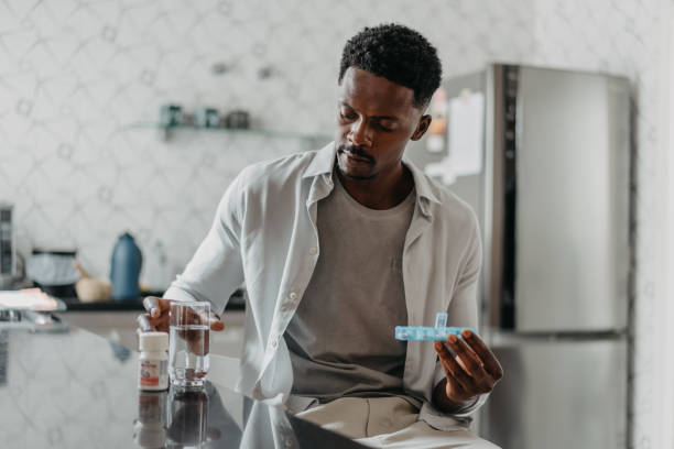 istock Man medicating himself at home medicine 1455111124