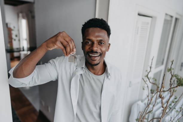 istock Man holding new house key 1455111269