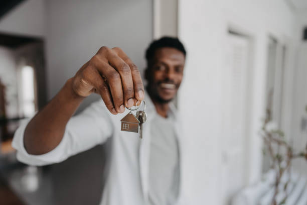 istock Man holding new house key 1455111278