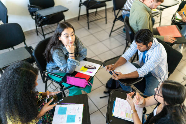 istock Circle of young friends talking while studying in the classroom at university 1455111399