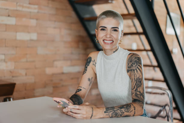 istock Woman using smartphone at home sitting at table 1455111478