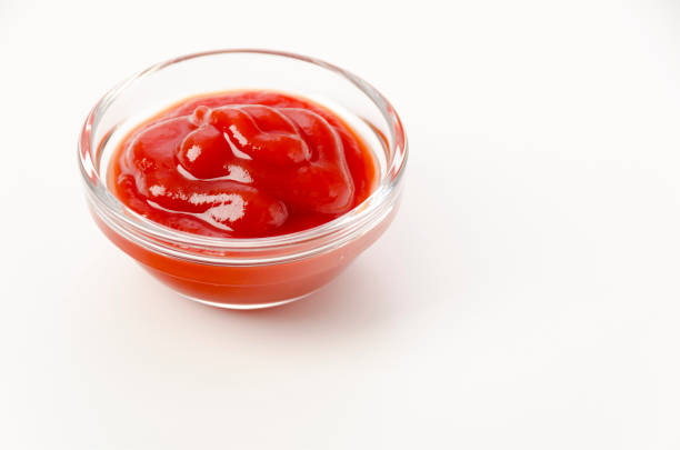 istock tomato ketchup in a small glass bowl on a white background 1455111574