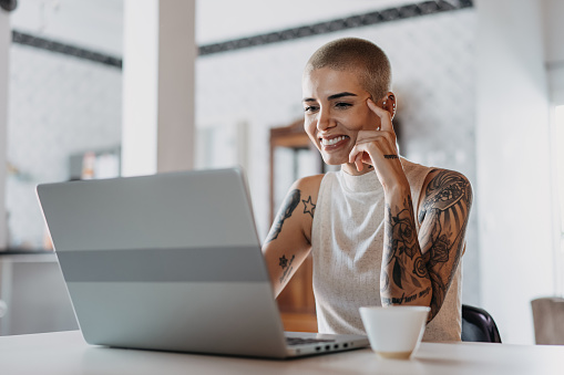 Portrait of woman using laptop at home