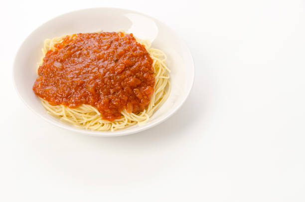 Spaghetti rolled on plastic fork with Tomato Sauce, Italian Food Close-Up