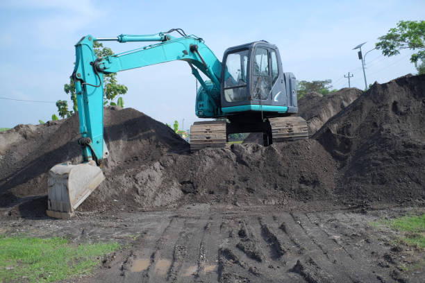 istock Mini excavator parked on a sand dune in an industrial area 1455116482