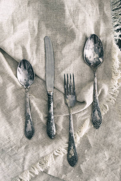istock Vintage silver cutlery set on linen napkin . 1455118921