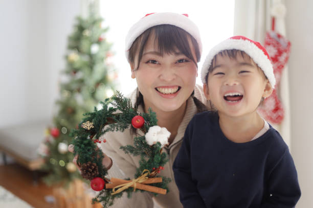 istock Parent and child with a handmade Christmas wreath 1455119043