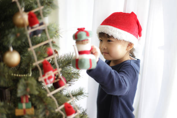 istock girl decorating christmas tree 1455119683