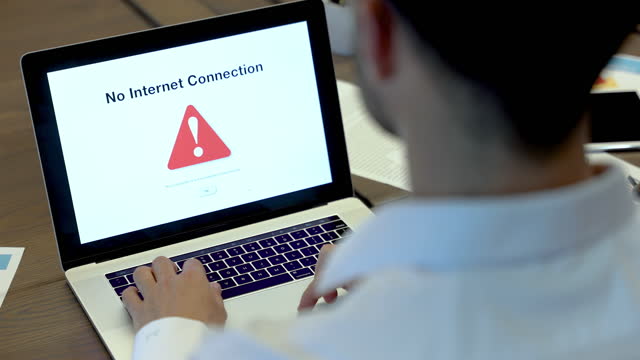 Businessman looking at an internet failure screen on a computer