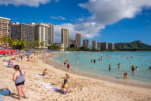 Honolulu, Hawaii - December 28, 2022:  Busy Waikiki Beach on a beautiful day during Christmas Break.