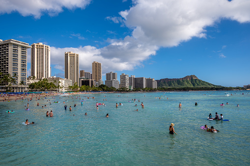 Honolulu, Hawaii - December 28, 2022:  Busy Waikiki Beach on a beautiful day during Christmas Break.