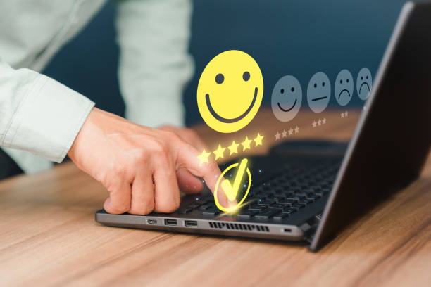 istock Man hand using computer laptop with popup five star icon for feedback review satisfaction service, testimonial. Customer service experience and business satisfaction survey. 1455128265