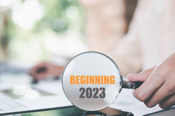 istock New Year 2023 Beginning Concept,man holding a magnifying glass,Finding new goals to develop and expand the business,future changes for success,direction and action for strategic planning 1455128338